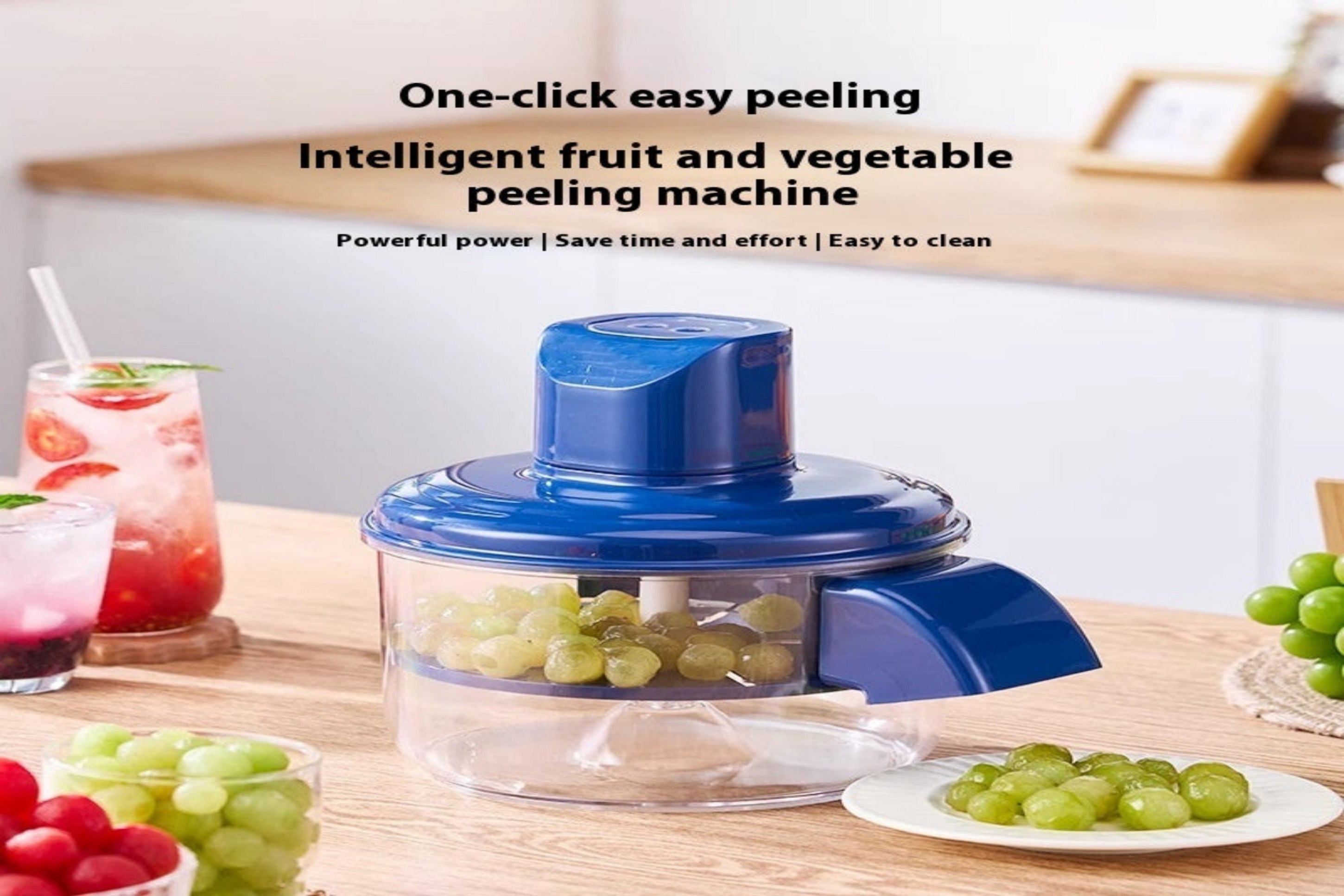 Blue fruit and vegetable peeling machine on a kitchen counter with grapes and a drink in the background.